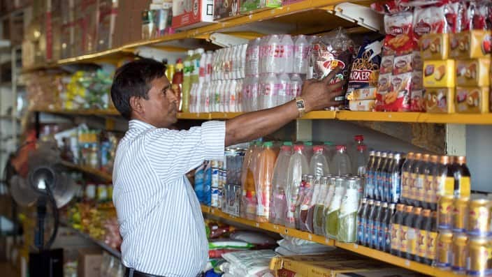 Rohingya refugee Kobir Ahmed working inside a grocery store.