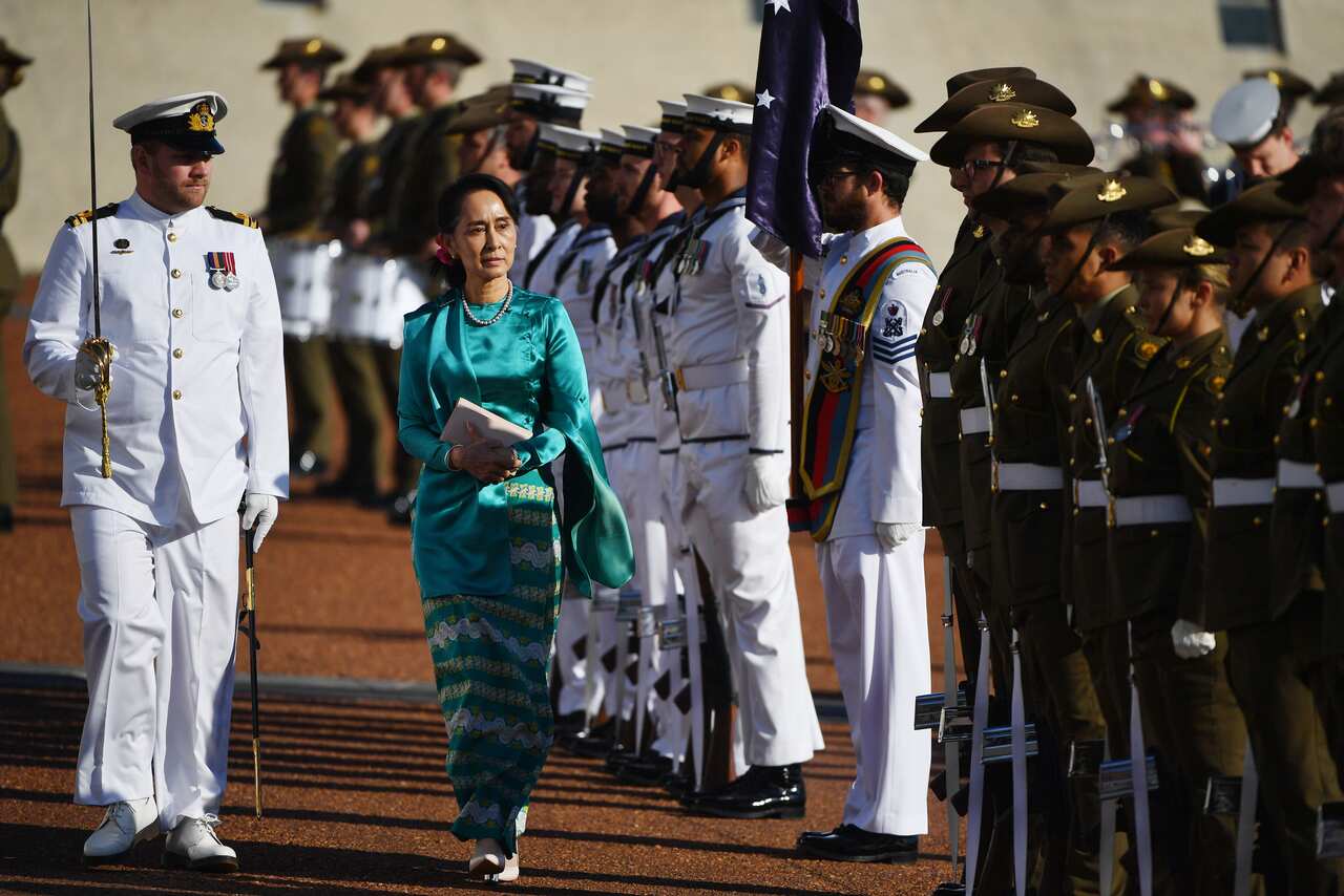 Myanmar's State Counsellor Aung San Suu Kyi inspects the guard during a ceremonial welcome at Parliament House in Canberra