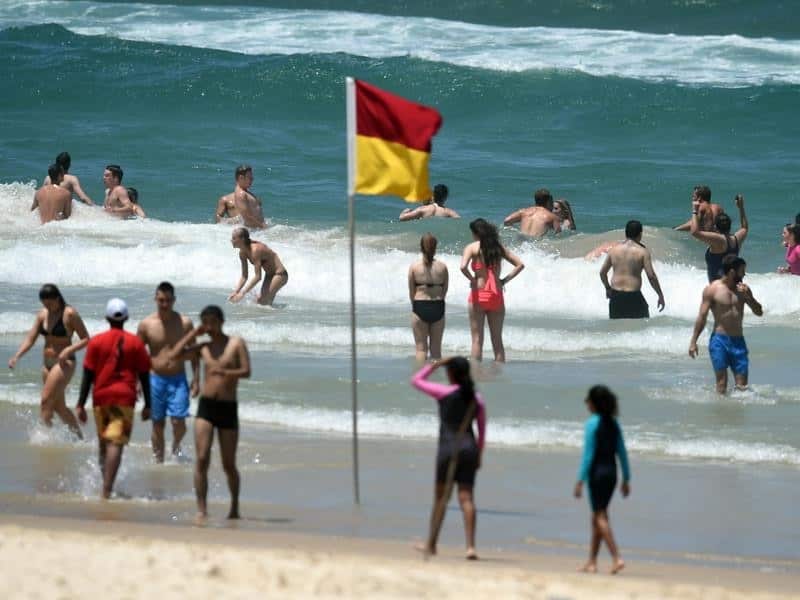 Beachgoers cool down in the water
