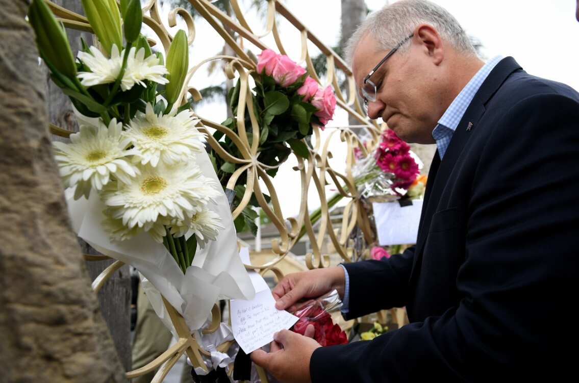 Prime Minister Scott Morrison looks at floral tributes to the victims of the Christchurch terror attack during a visit to the Lakemba Mosque.