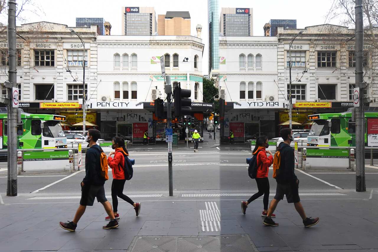 People are seen wearing masks in the central business district in Melbourne.