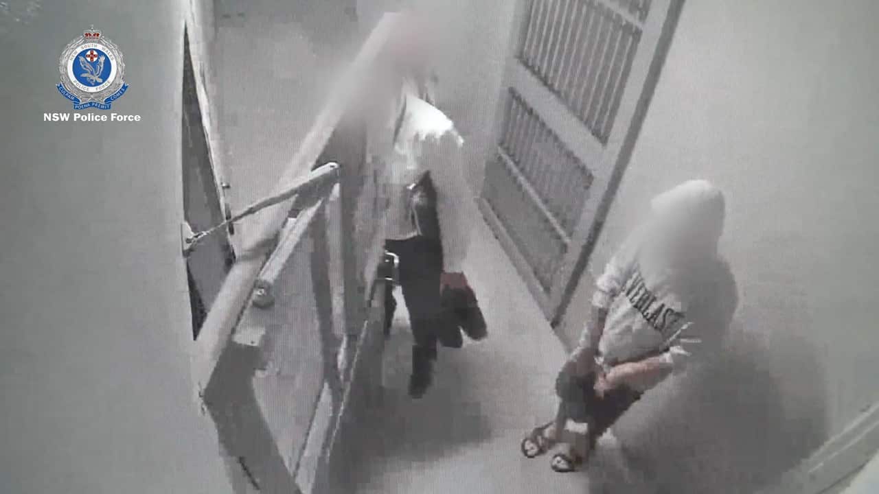 A supplied CCTV image shows Justin Laurens Stein (right) after his arrest in Sydney on Tuesday, 18 January, 2022. 