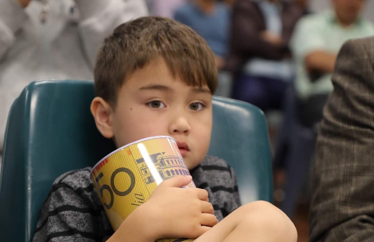 A young boy attended the event to donate what he had in his saving tin.