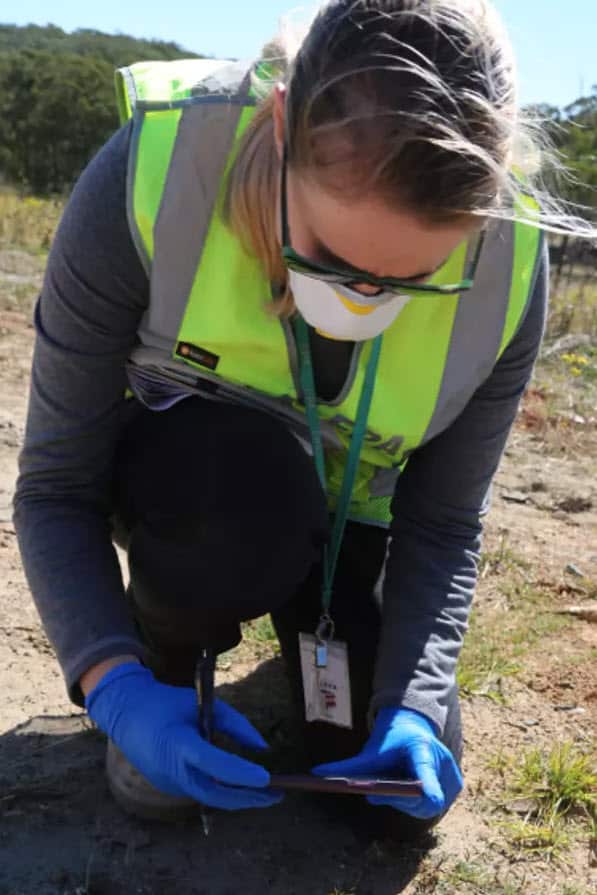 An EPA officer inspects waste at the property.