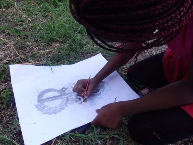 Kid putting on paper art lessons from Wise