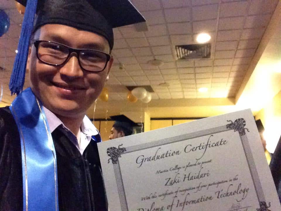 Zaki Haidari is awarded his graduation certificate for a Diploma of Information Technology.