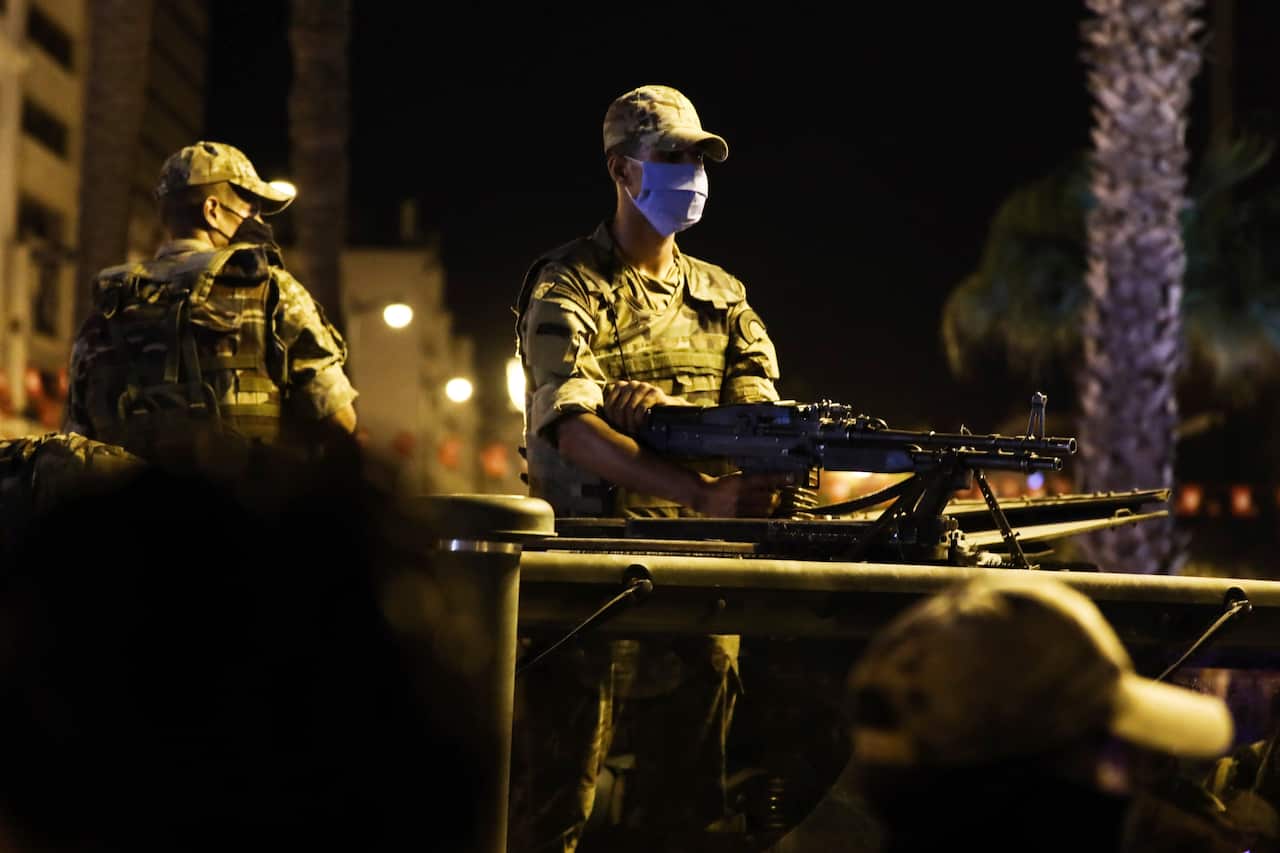 Soldiers stand by as supporters of Tunisia's President Kais Saied gather on the streets