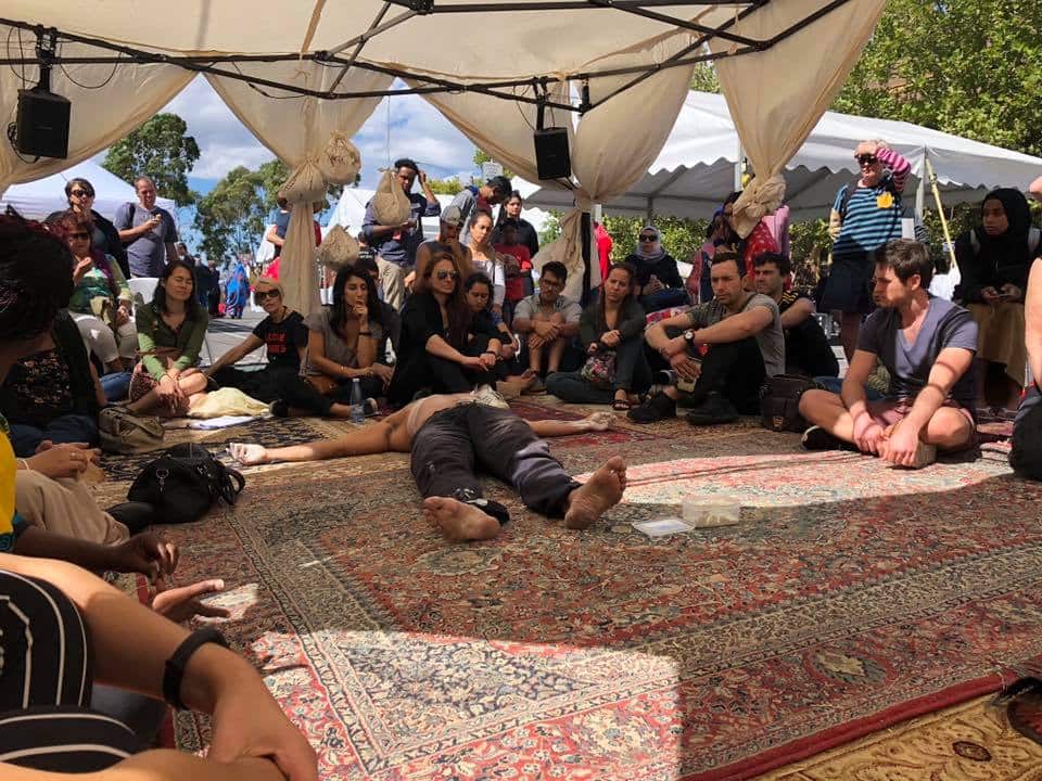 Audience members at a "Bukje" event highlighting the journey of refugees.
