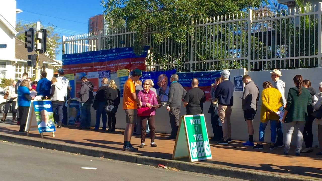 A line outside a voting booth