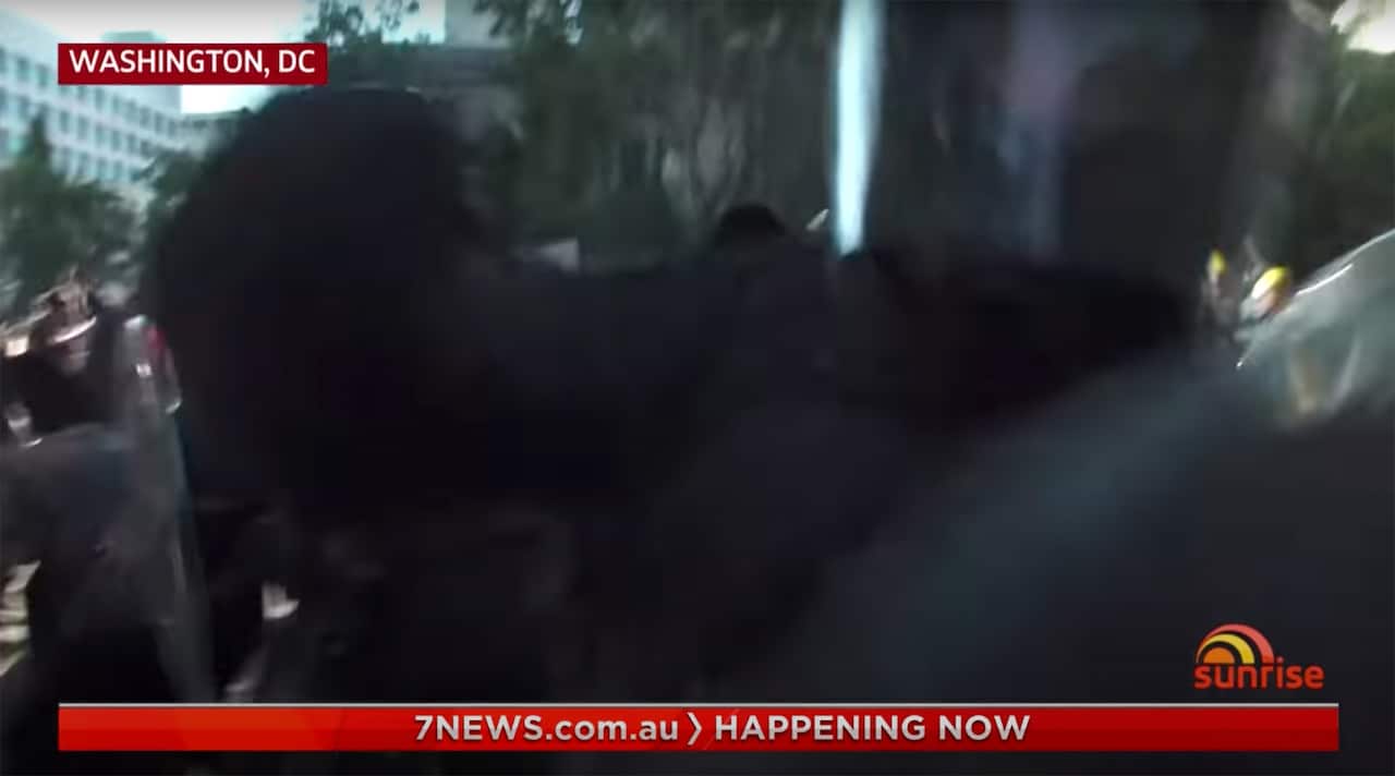 A police officer goes for the camera as the Network Seven crew were broadcasting live. 