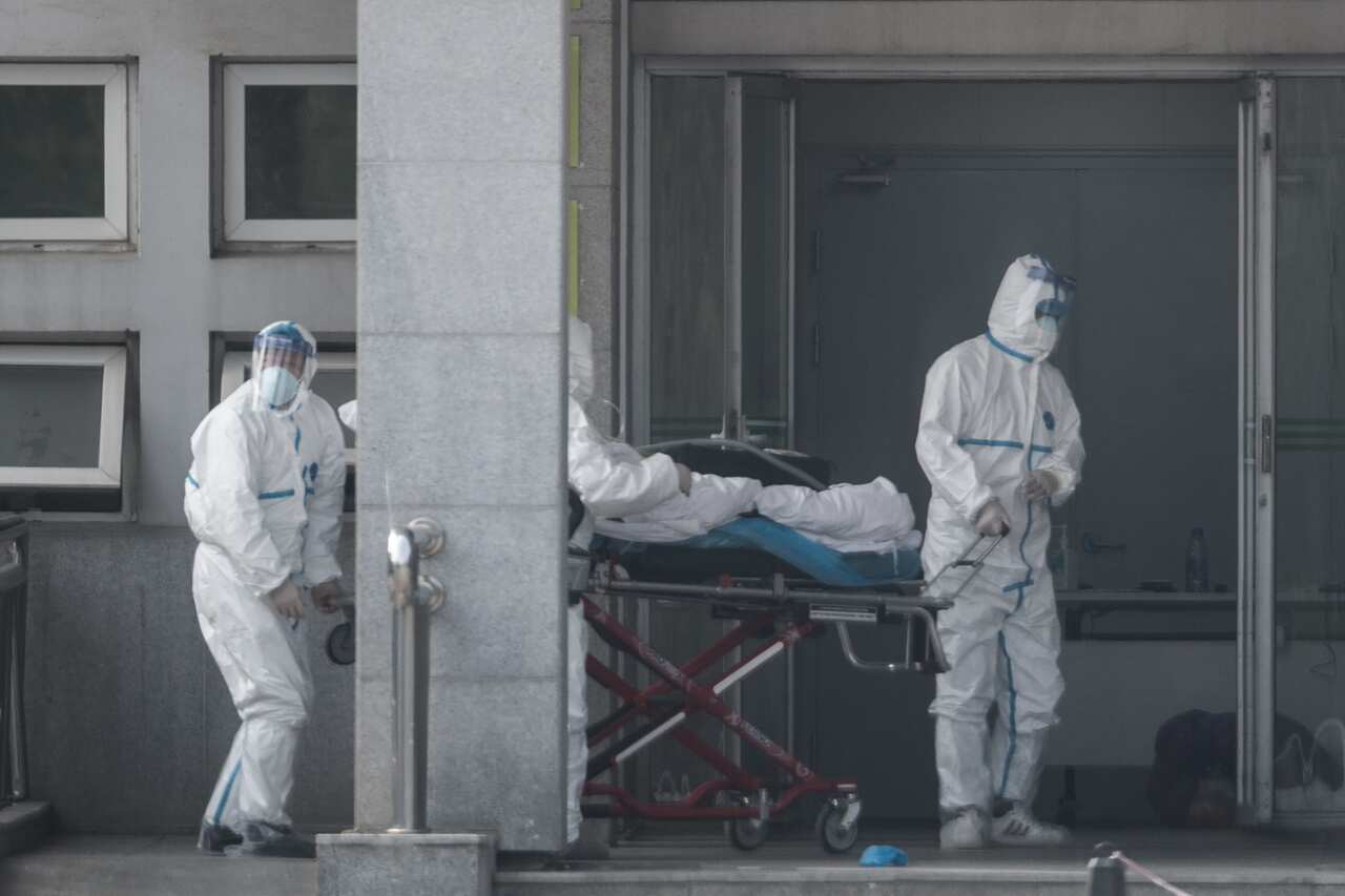 Medical staff carry a patient into the Jinyintan hospital where patients infected with a new strain of coronavirus are being treated in Wuhan, China.