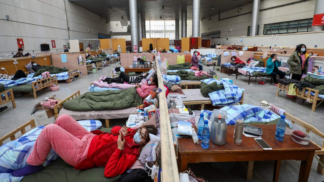 People rest in a temporary hospital situated in the Tazihu Gymnasium in Wuhan, Hubei province.