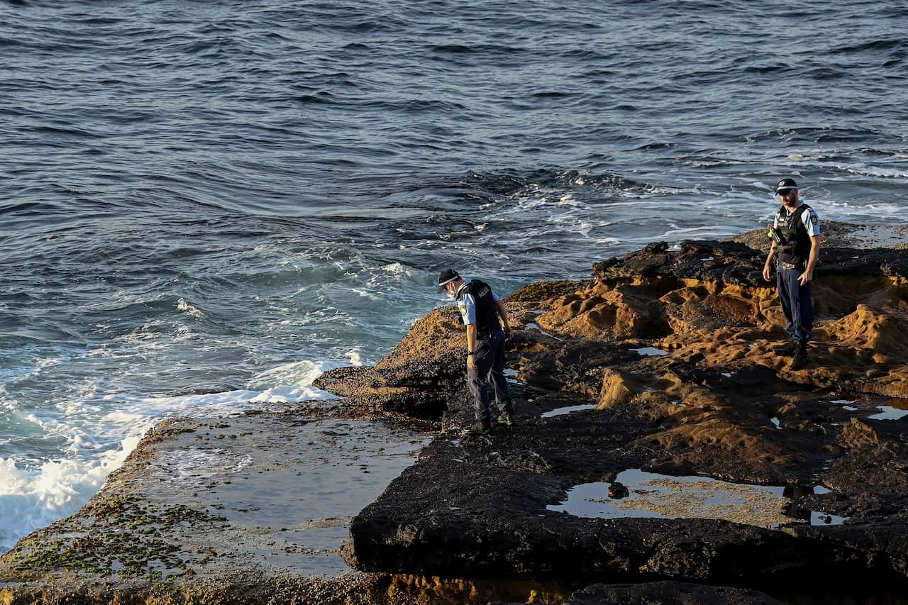 NSW Police search the waters edge at Buchan Point in Malabar, off Little Bay Beach in Sydney, on 17 February.