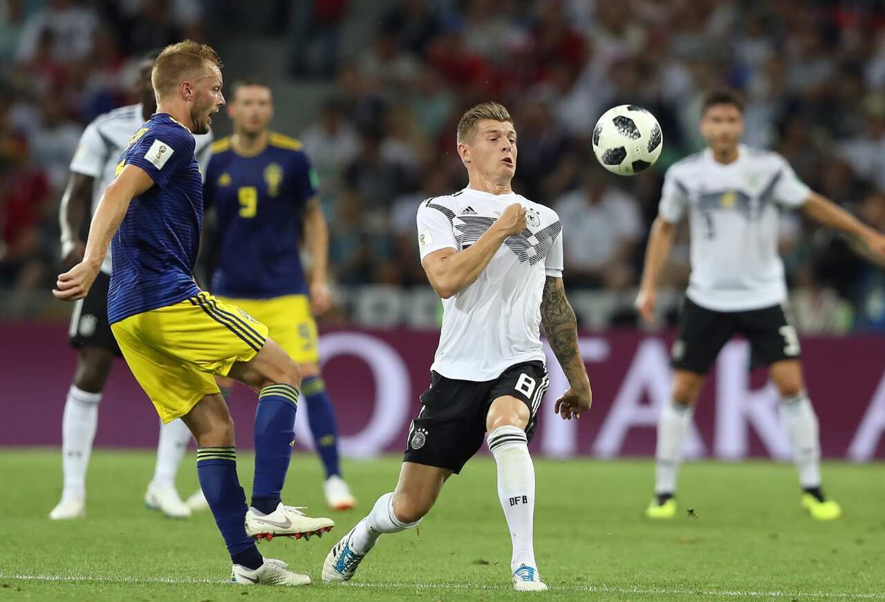Sebastian Larsson of Sweden (L) and Toni Kroos of Germany in action 