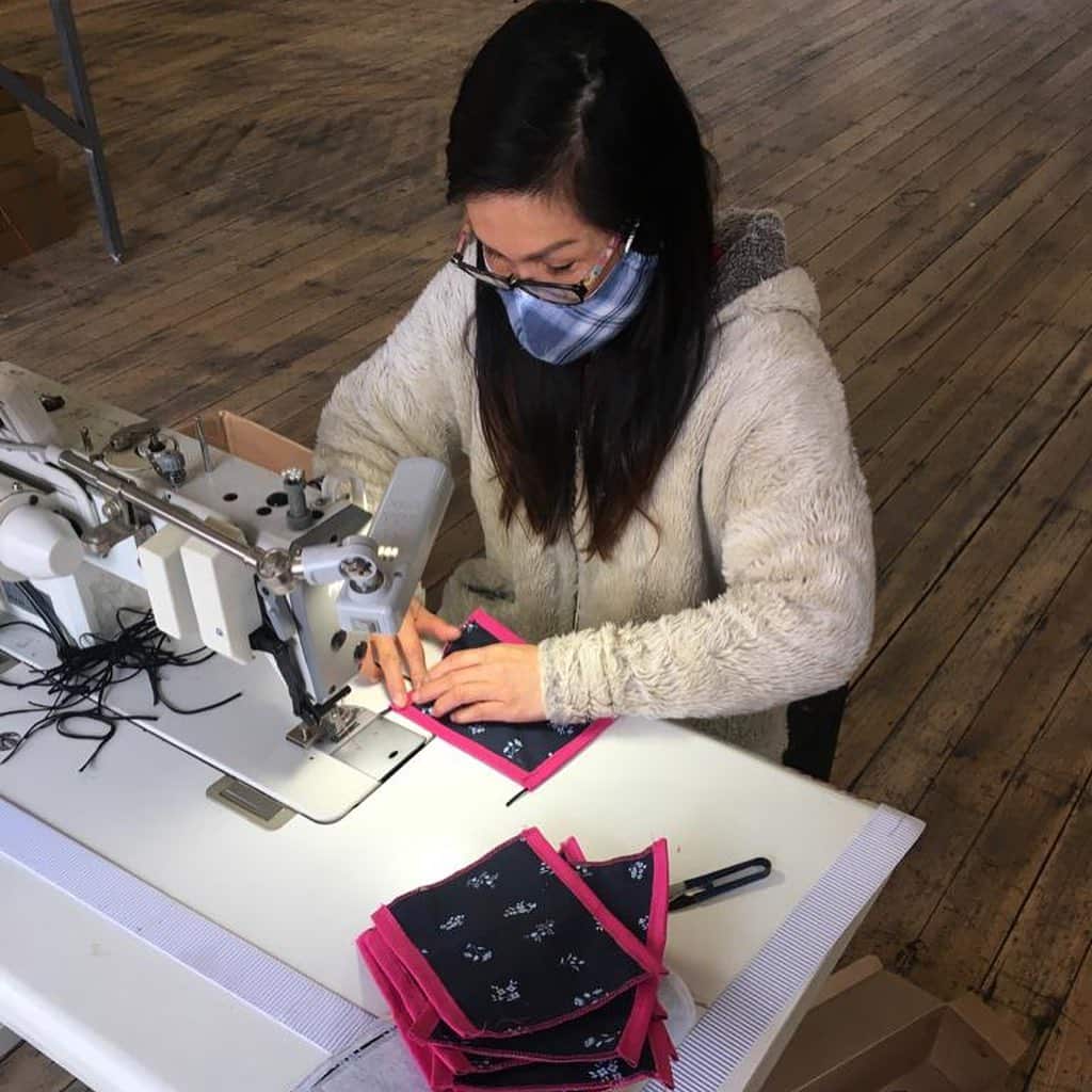 A Social Studio staff member sews reusable masks. 