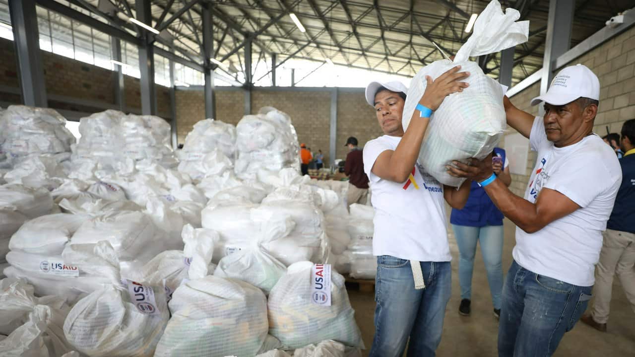 Venezuelan volunteers place a bag of humanitarian aid for storage at a warehouse near the border with Venezuela.