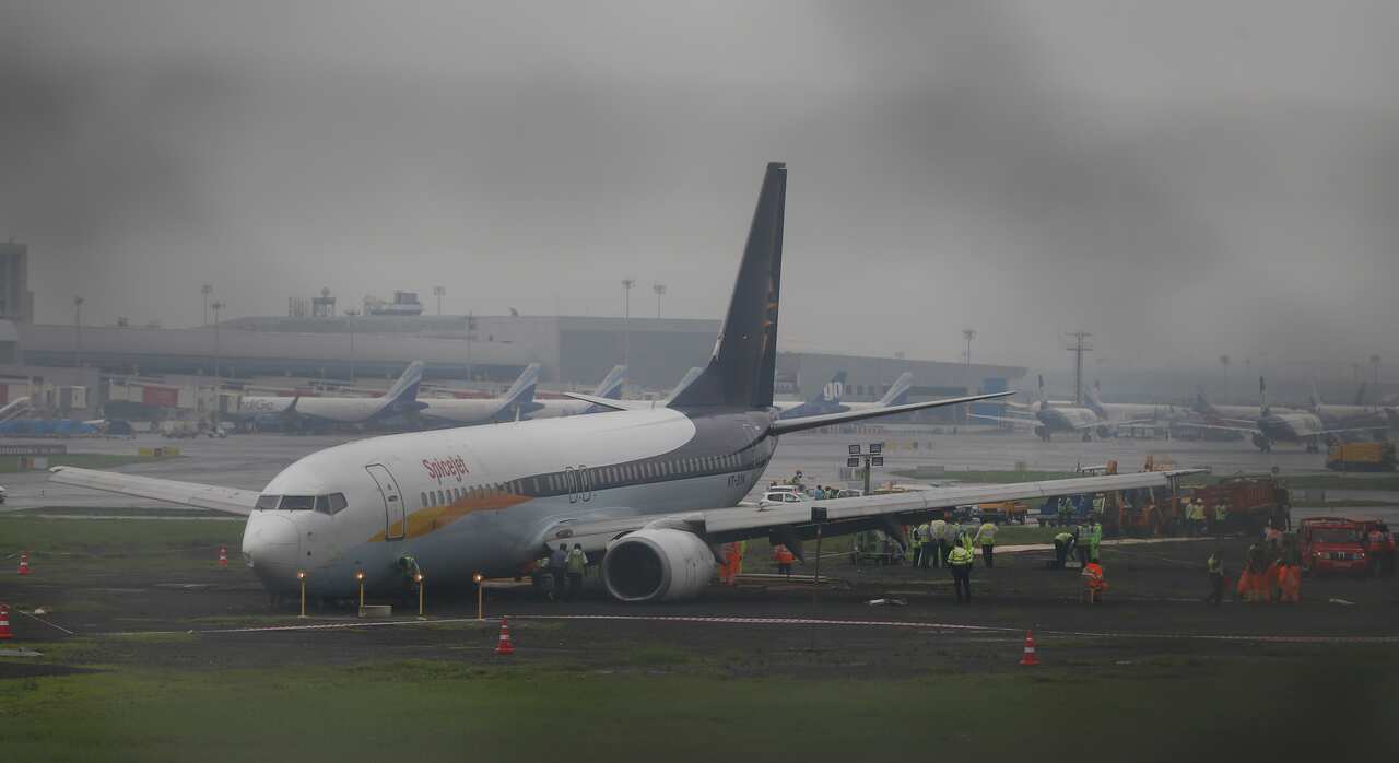 A domestic flight that skidded off the main runway late Monday night during heavy monsoon rains is see at the Mumbai airport in Mumbai,India, Tuesday, July 2, 2019. (AP Photo/Rafiq Maqbool)