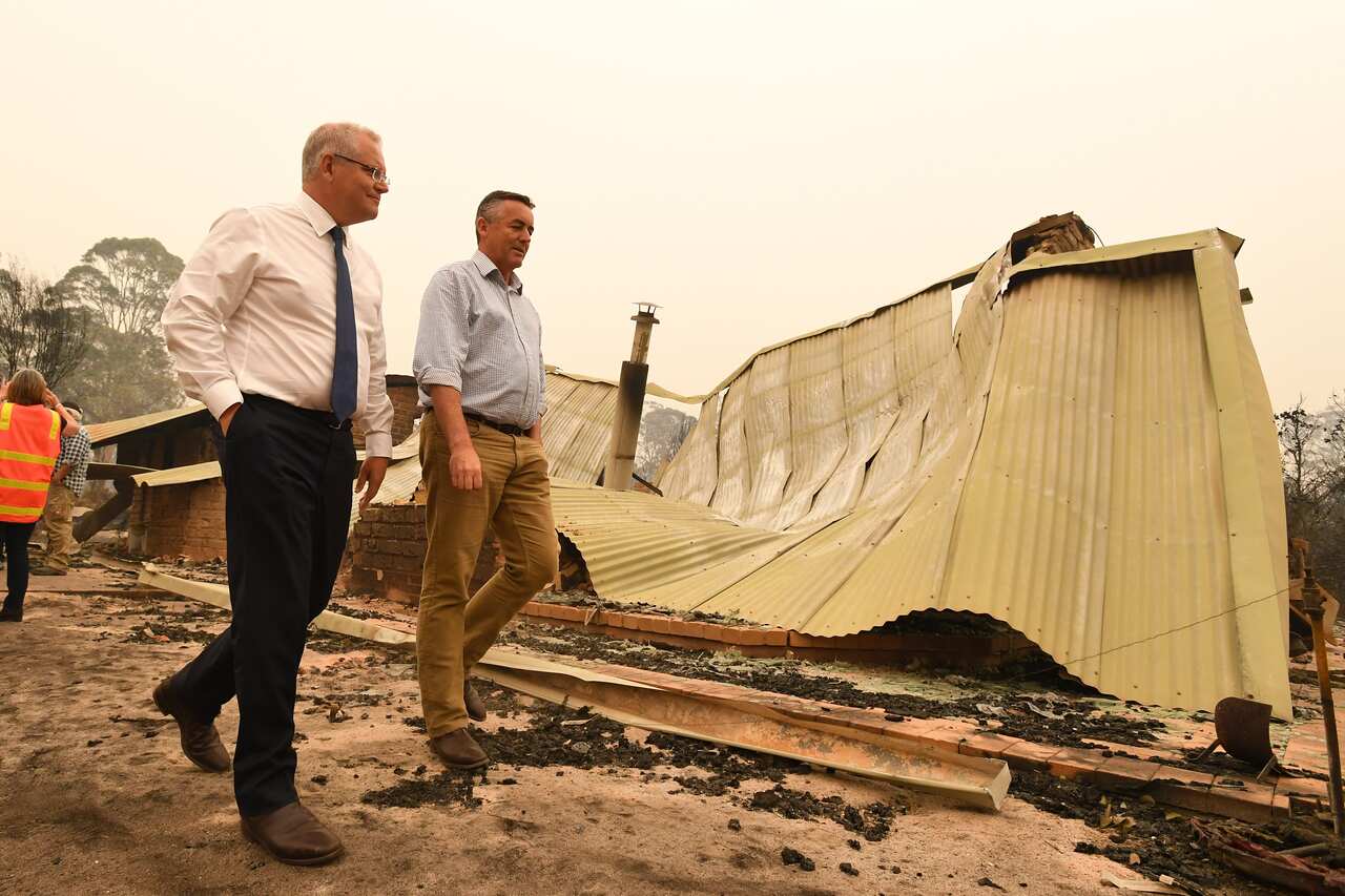 Prime Minister Scott Morrison (left) and Darren Chester MP tour the fire-ravaged Wildflower farm owned by Paul and Melissa Churchman in Sarsfield, Victoria.