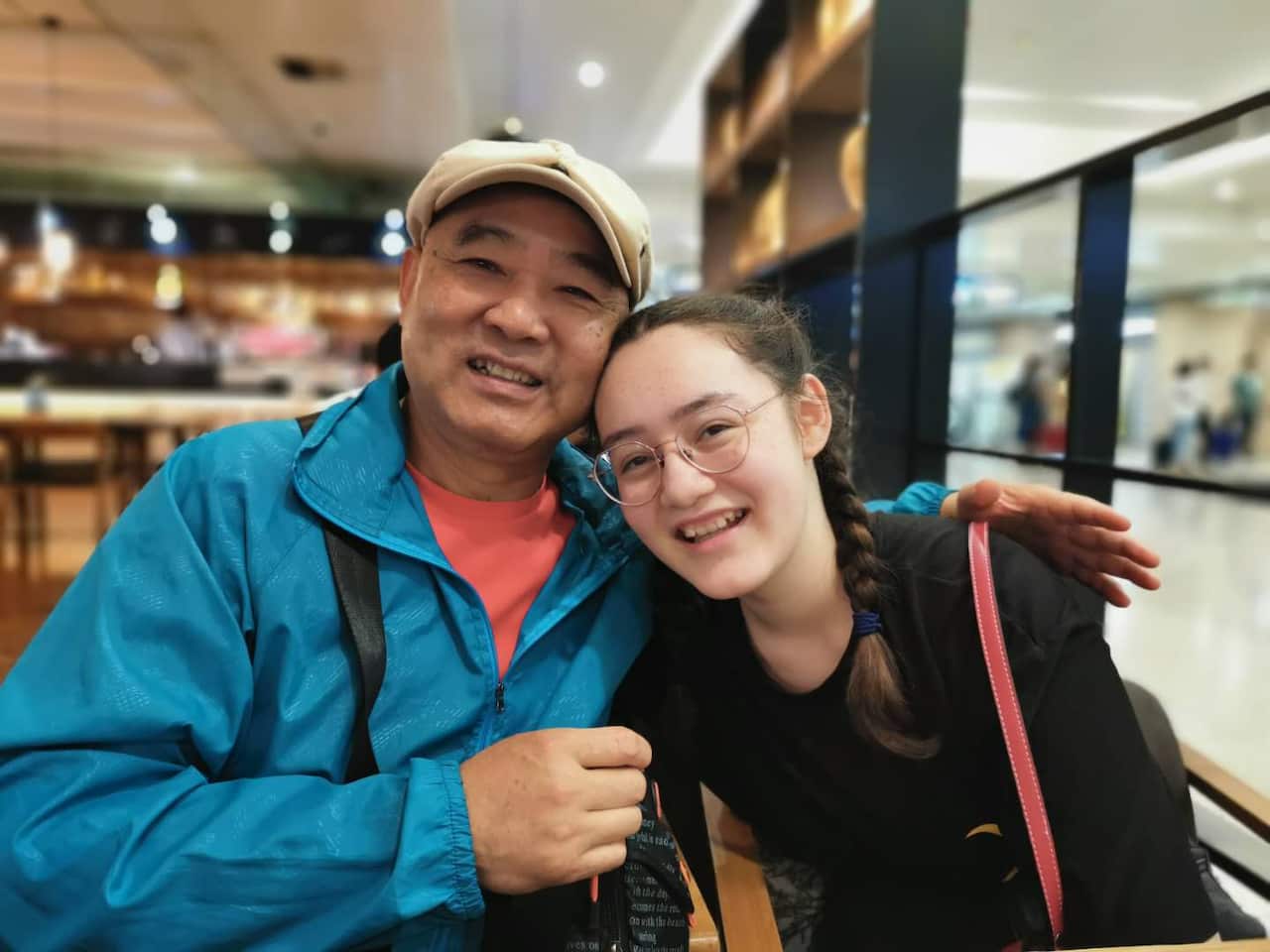 Jessica Xie-Moulton at Wuhan International Airport with her grandfather. 