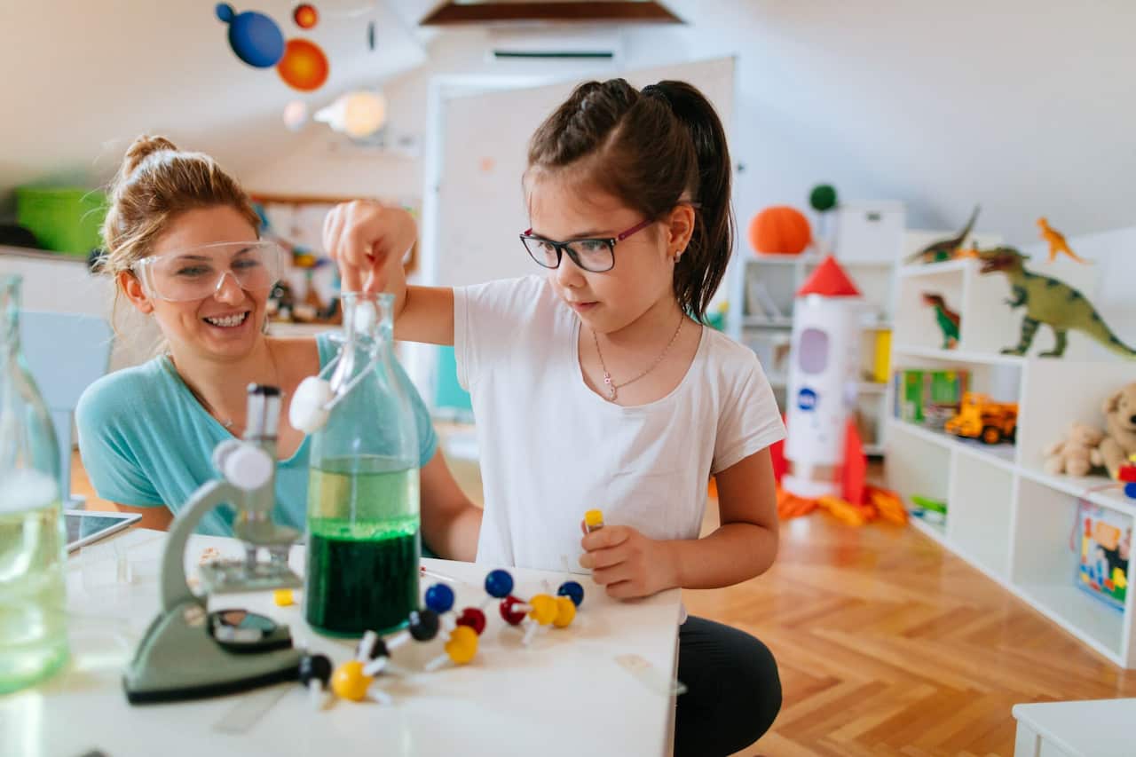 Girl and her mother doing scientific experiment