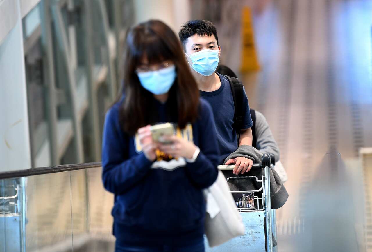 Passengers wear face masks at the International Airport in Brisbane