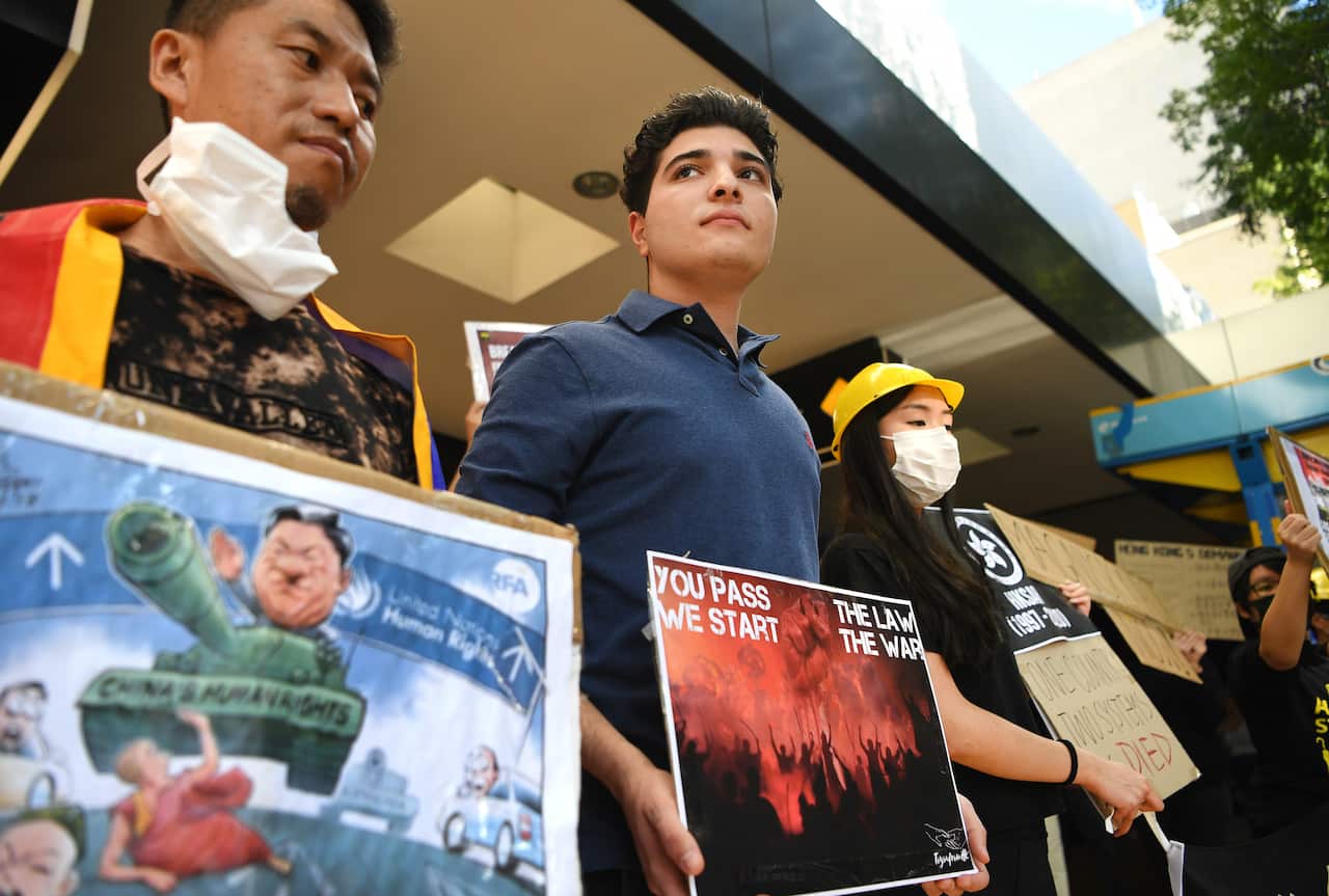 University of Queensland (UQ) student and activist Drew Pavlou (centre) takes part in a protest in support of Hong-Kong.