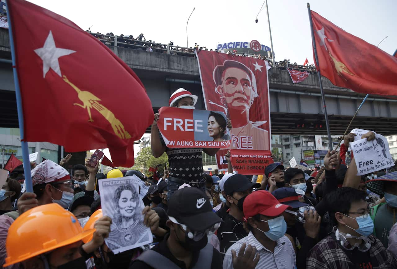 Demonstrators hold banners calling to free Aung San Suu Kyi during a protest against the military coup in Yangon