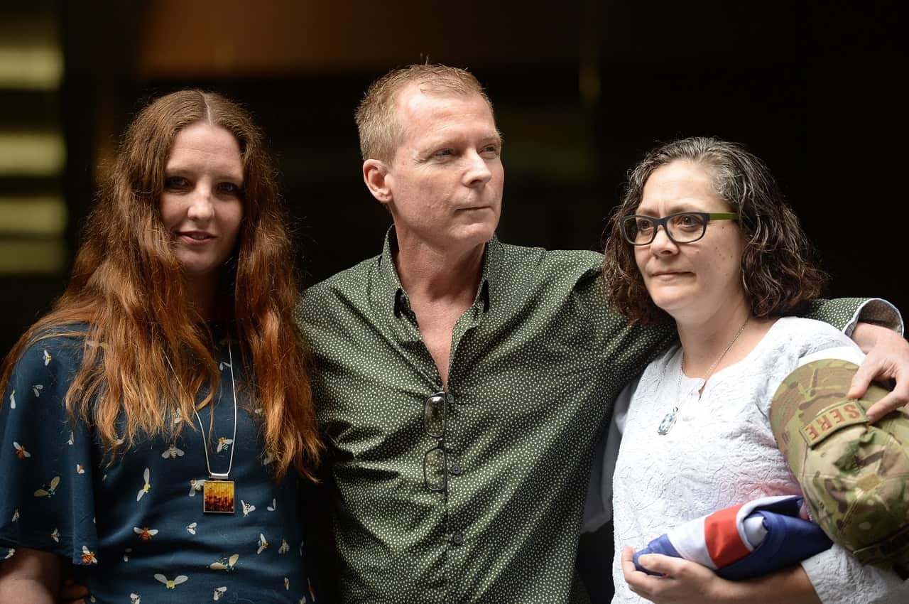 Timothy Weeks poses for a photograph with his sisters Alyssa Carter (left) and Joanne Carter (right) in Sydney.