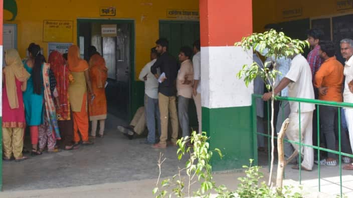Voters stand in a queue to cast their votes during the first phase of the Indian elections