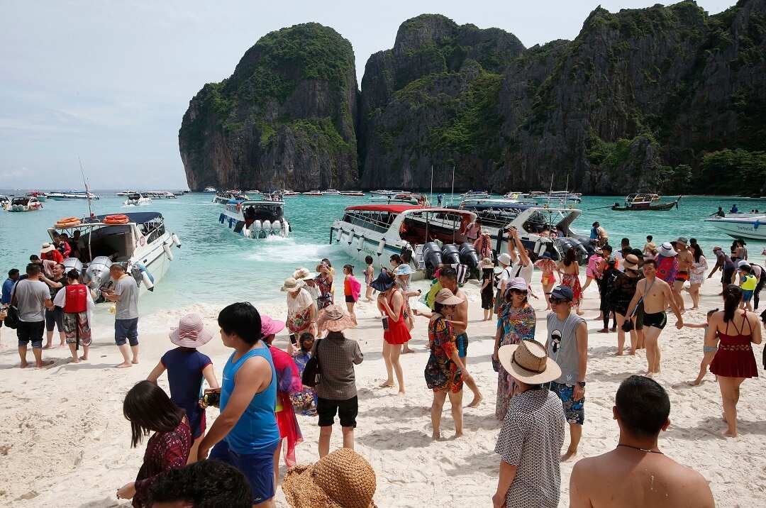 Tourists visit Maya Bay, the beach made famous by Danny Boyle’s film The Beach.