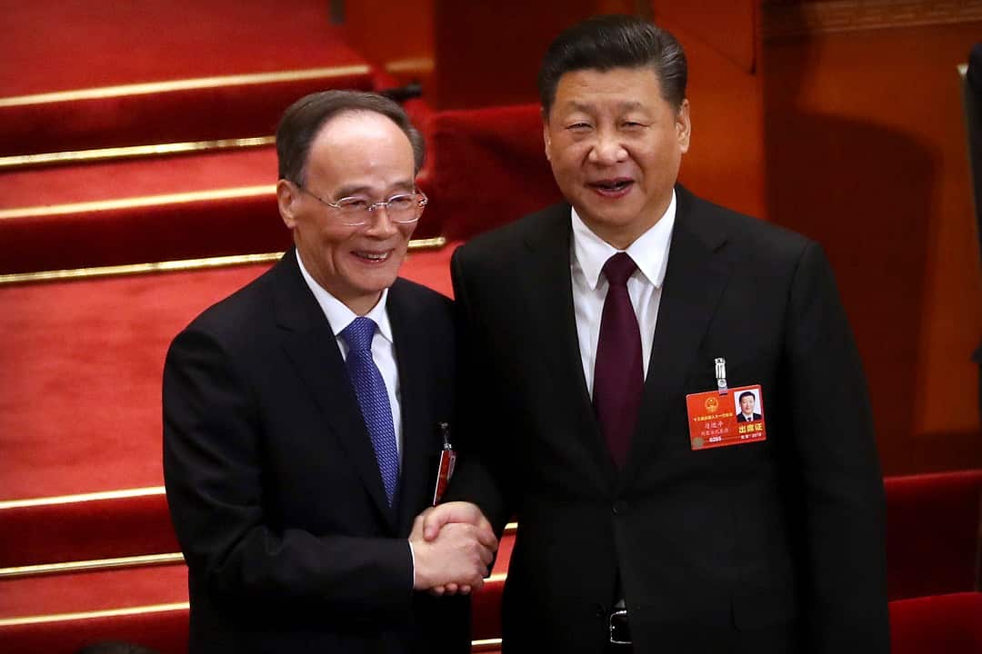 Chinese President Xi Jinping, right, shakes hands with Wang Qishan after Wang was elected Vice-President.