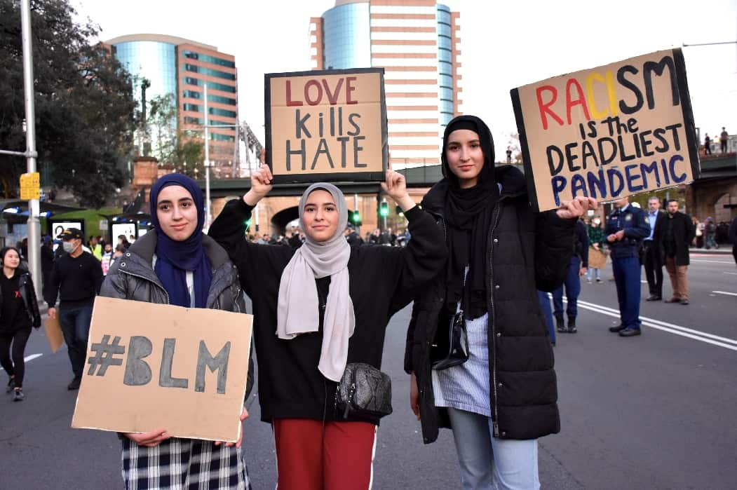 These women are showing their support for the Black Lives Matter movement and calling for an end to racism. 