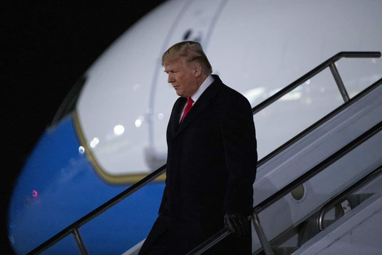 Donald Trump lands in Michigan, set to attend a campaign rally while the House voted on his impeachment.