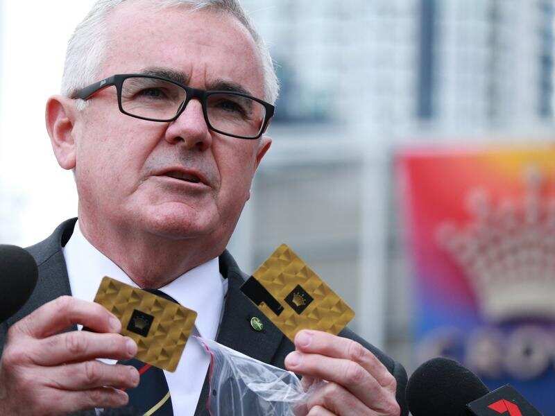 Independent MP Andrew Wilkie displays Crown Casino VIP member cards.
