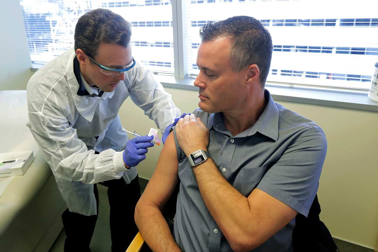 Pharmacist Michael Witte gives Neal Browning a shot