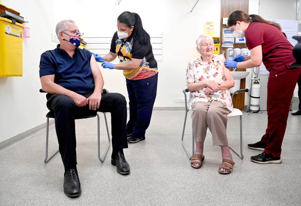 Australian Prime Minister Scott Morrison (left) and Jane Malysiak (right) receive their COVID-19 booster vaccination at Kildare Road Medical Centre in Blacktown in Sydney, Friday, November 19, 2021. (AAP Image/Pool, Jeremy Piper) NO ARCHIVING