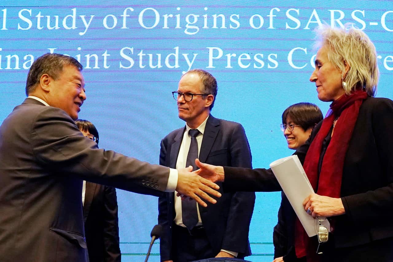 Marion Koopmans and Peter Ben Embarek of the WHO team farewell their Chinese counterpart Liang Wannianin in Wuhan, China, 9 February 2021.
