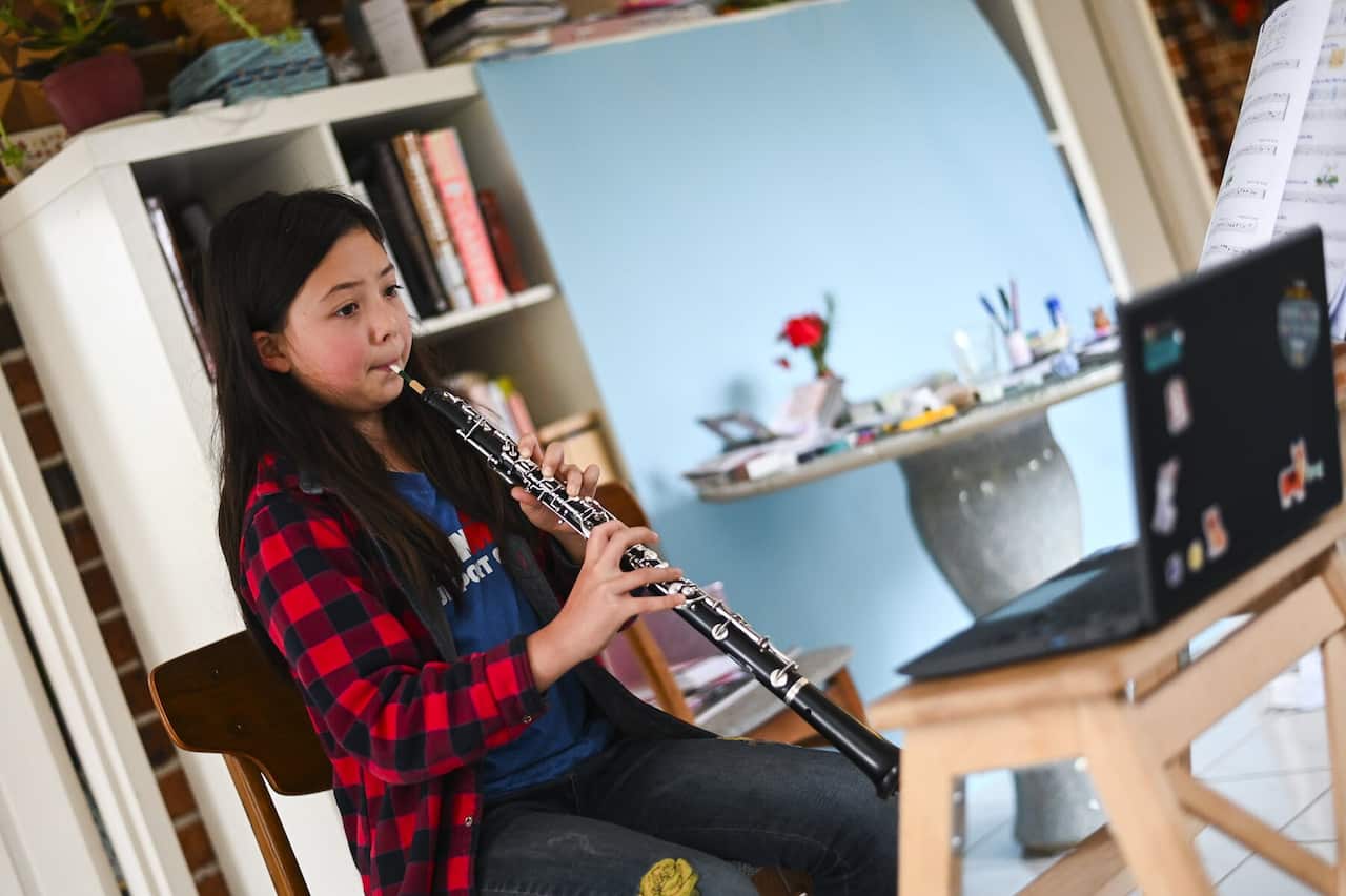 A student completes an online music lesson in Canberra