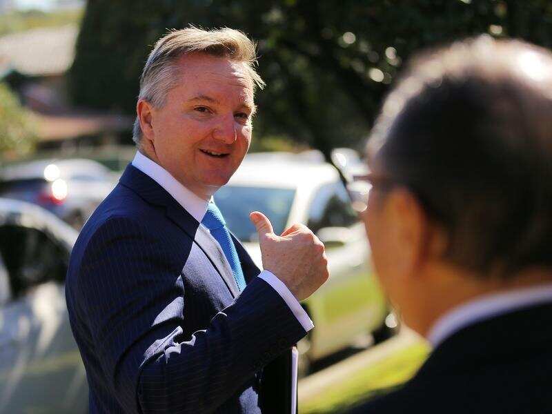 Shadow Treasurer Chris Bowen gestures before leaving a doorstop.