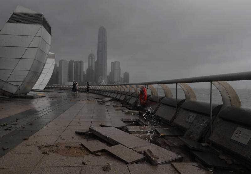 Debris caused by Typhoon Hato damage is strewn across the waterfront of Victoria Habour in Hong Kong.