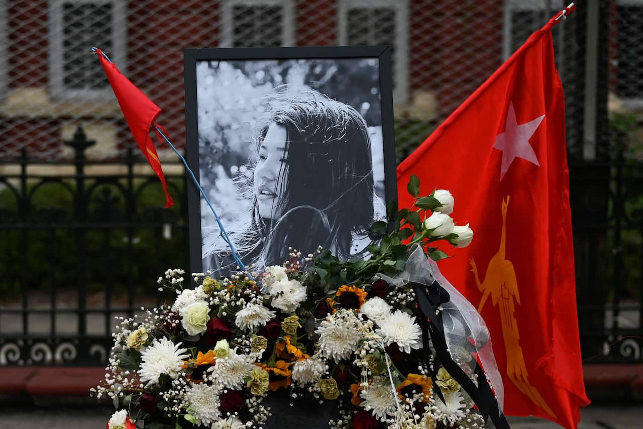 Flowers, a portrait and flag of the National League for Democracy party are displayed in honour of Mya Thwate Thwate Khaing, during a demonstration in Yangon.