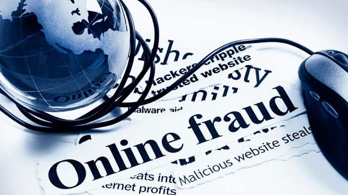 Glass world globe and computer mouse on Online Fraud headlines