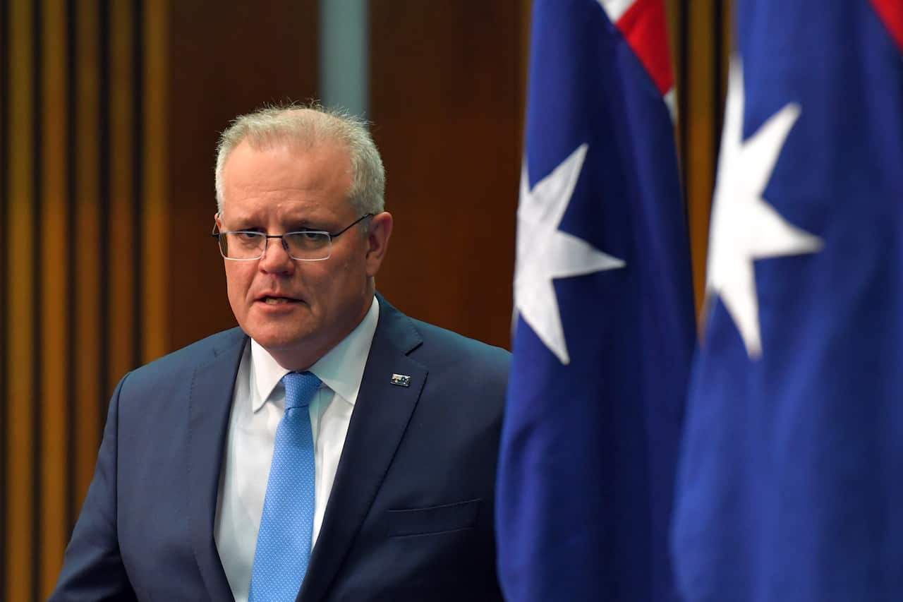 Prime Minister Scott Morrison arrives at a press conference at Parliament House in Canberra on 21 August.