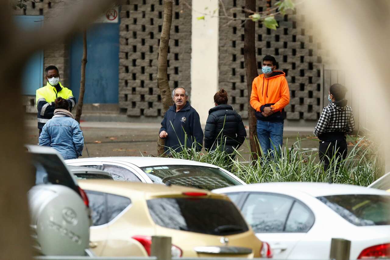 People are seen outside public housing towers in North Melbourne on Sunday. 