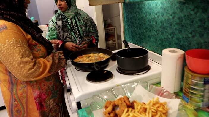 Sabeen Nisar cooking food for the iftar at her home.