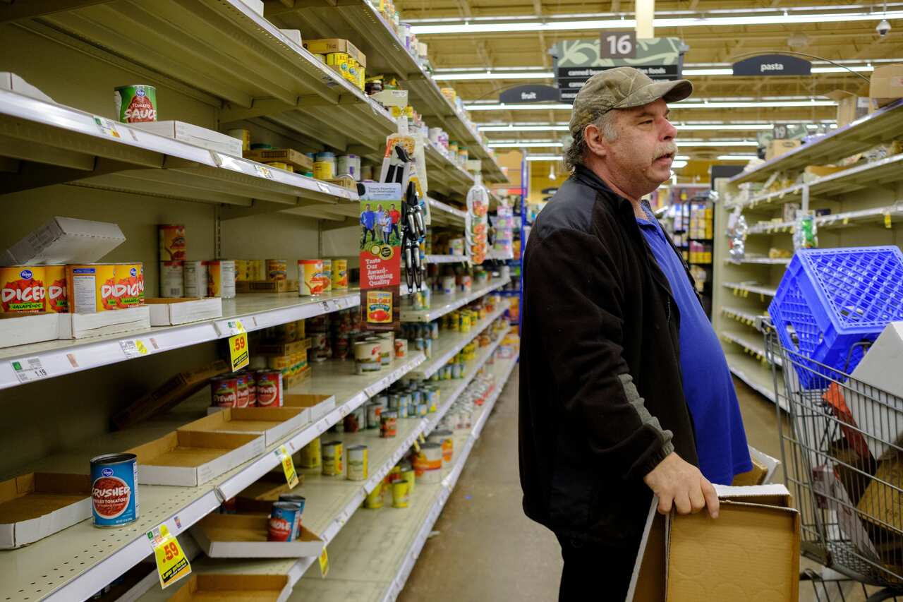 A worker at a Kroger in Bloomington, US, restocks shelves.