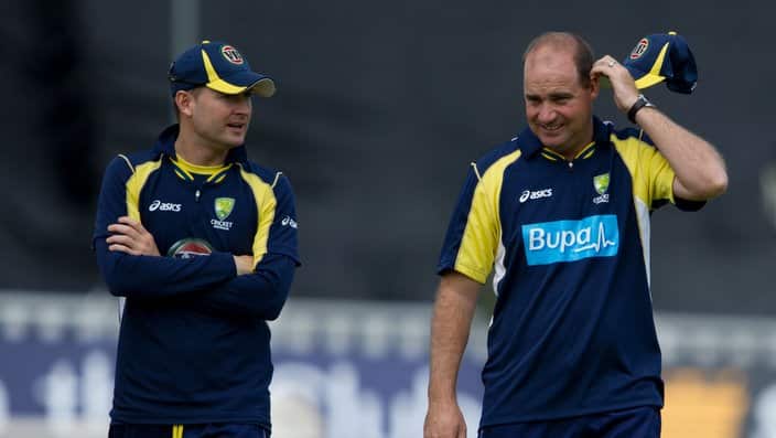 Australia's Michael Clarke, left, speaks to  coach Mickey Arthur, right, as rain delays their one day international cricket match against England at the Egdbaston cricket ground, Birmingham, Wednesday July 4, 2012. (AP Photo/Tom Hevezi)