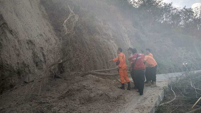 Emergency services inspecting a damaged road after an earthquake struck in Lombok.