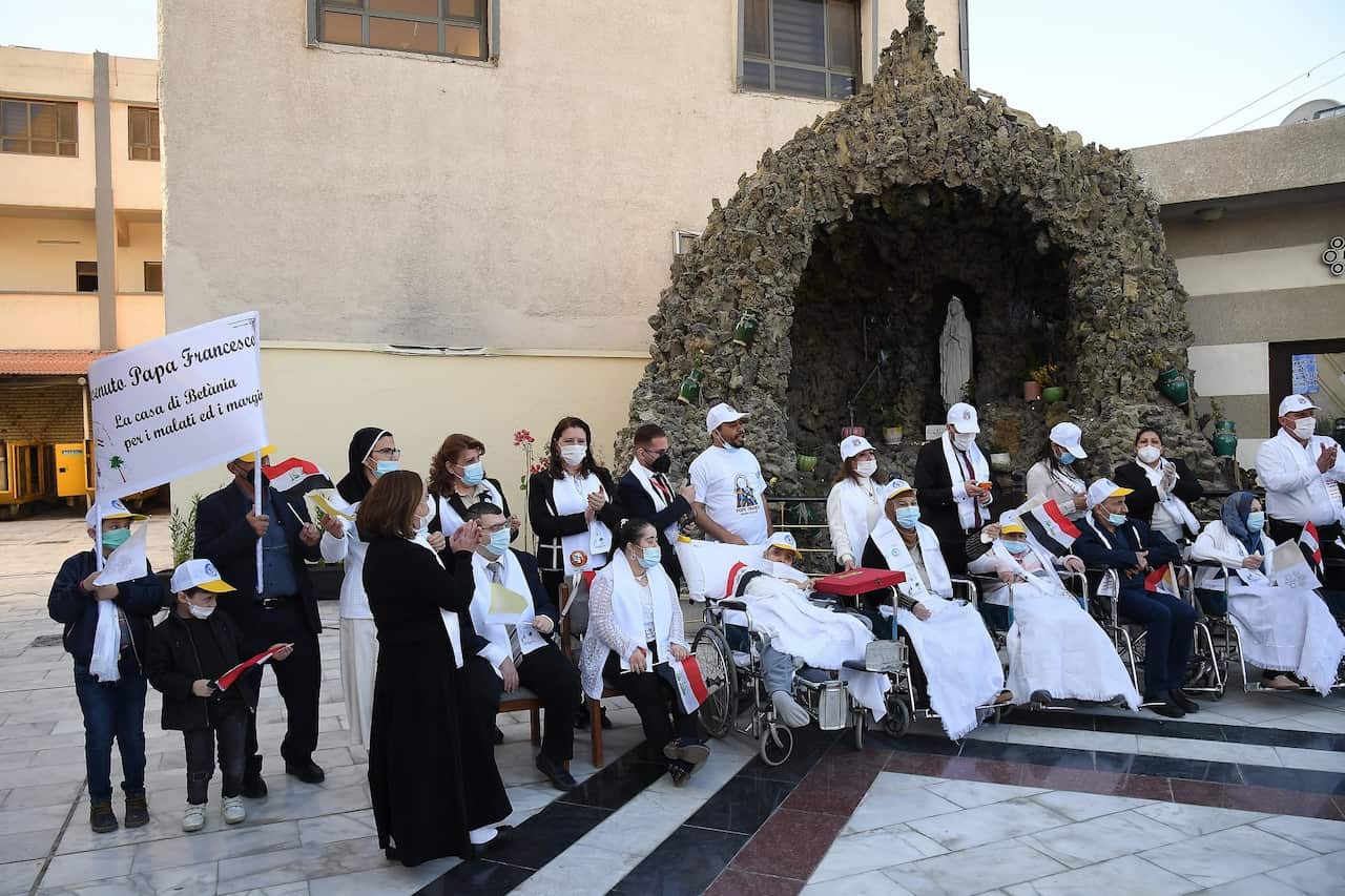 Church attendees wait for Pope Francis' arrival at the Syro-Catholic Cathedral of Our Lady of Salvation in Baghdad, Iraq.