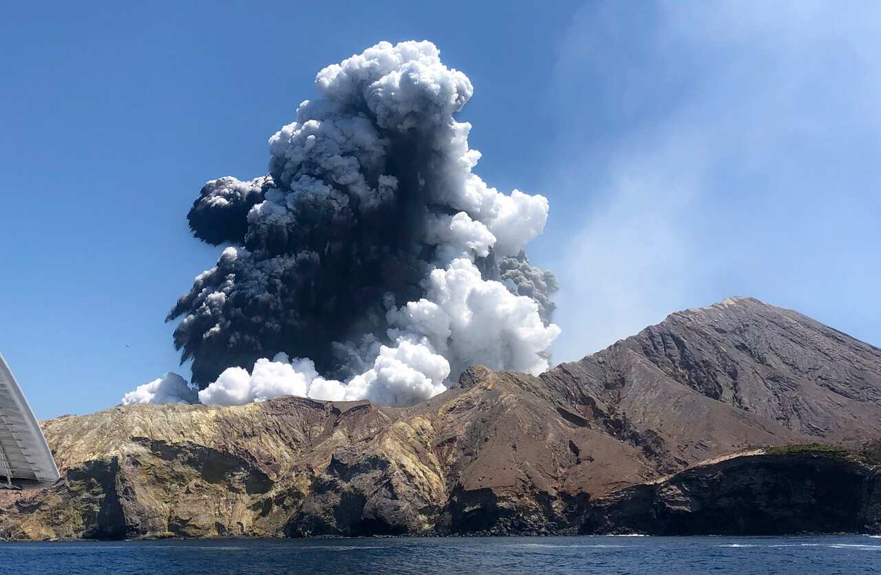 Ash spews into the air on White Island, off the coast of Whakatane, New Zealand.